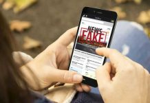 Person reading FAKE NEWS on smartphone