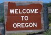 Welcome sign to Oregon with a brown background and white text