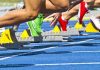NCAA BANS Trans Athletes—Campus Uproar Erupts Athletes starting a sprint from starting blocks on a blue track