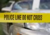 Deadly First Date—Woman Dodges Blame Yellow police tape reading POLICE LINE DO NOT CROSS in front of a vehicle