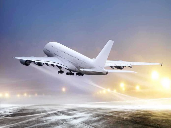 shutterstock_94244692.jpg An airplane taking off from an airport runway against a twilight sky