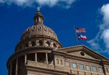 Abbott’s Tariff Bombshell—Texas Draws the Line Building dome with US and Texas flags blue sky