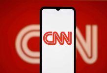 Conservative Warrior TRIGGERS CNN Panic Mode CNN logo on a phone screen.