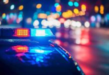 Police Cover-Up Bombshell Shakes Massachusetts Police car with flashing lights at night.