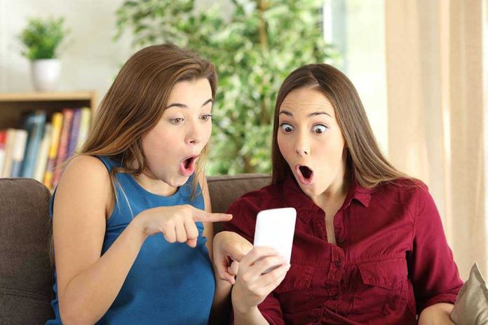 Two women look surprised at a phone
