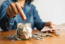 Retail Chaos Looms: Goodbye Precious Pennies Person placing a coin into a savings jar labeled 'SAVINGS'