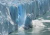 A glacier calving into the ocean, creating a splash of ice and water