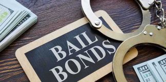 Bail bonds sign with handcuffs and stacks of cash