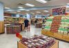 Interior of a grocery store with customers shopping for fresh produce