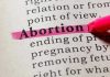 Grassroots INSURGENCY — Abortion Wars Heat Up in Texas Abortion highlighted in a dictionary with a pink marker.