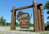 Explosive Judge Scandal Rocks Wisconsin Trump Case Wisconsin welcome sign with industry, agriculture, and recreation.