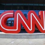 Pipe Bomb Suspect Found—Media’s Race Angle Criticized Large red CNN sign outside building entrance.