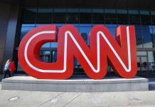 Pipe Bomb Suspect Found—Media’s Race Angle Criticized Large red CNN sign outside building entrance.