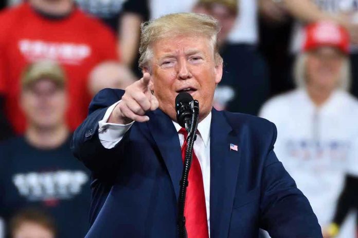 1585237510 Man in suit pointing, speaking at a rally.