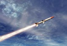 A missile ascending into the sky with a trail of smoke