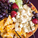 Massive Cheese Recall: Hidden Metal Threat A colorful cheese and fruit platter featuring various cheeses and fresh fruits