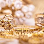 Close-up of various gold rings adorned with sparkling gems