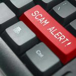 $7M Boston Bodega Scam EXPOSED! Close-up of keyboard with red SCAM ALERT key.