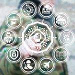 Which Jobs Go First When AI Takes Over Person interacting with futuristic holographic interface and icons.