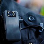 Officer ‘Murder-Suicide’ Triggers Questions Body camera attached to a black uniform.
