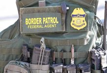 ICE Photo Rage Turns UGLY Fast Border Patrol vest with gear and communication equipment.