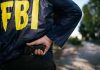 FED Buildings Breached — Trump Flips Switch FBI agent holding a gun behind the back.