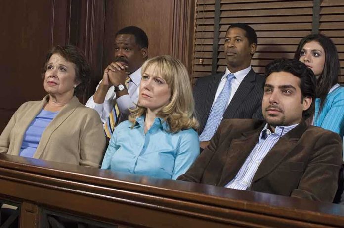 shutterstock_121503358.jpg A diverse group of jury members sitting in a courtroom with serious expressions