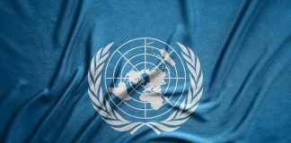 United Nations flag featuring a world map and olive branches on a blue background