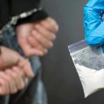 Vanished Evidence—Truth Behind Nebraska Drug Haul Person handcuffed, police holding bag of white substance.
