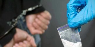 Vanished Evidence—Truth Behind Nebraska Drug Haul Person handcuffed, police holding bag of white substance.