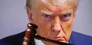 Gavel in front of a serious mans face.