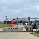 U.S. Quarantine: Secretive Details Stir Anxiety! Chain-link fence with Restricted Area Stop No Photography sign.