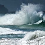 UN’s Declaration Over “100%” Tsunami Claim Crashing ocean waves against the shore under a cloudy sky