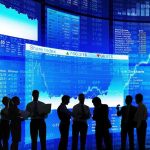 The Likely Grenade in the U.S.-China Summit… Silhouetted business professionals in front of digital stock market displays