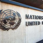 Controversial UN Agenda: Sovereignty at Stake Facade of the United Nations building featuring the UN emblem and text