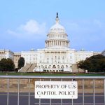 Public FURY Over Foreign Lobby War Claims View of the U.S. Capitol building with a security barrier in front