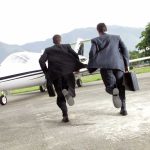 Navy’s Next-Gen Fighter Saved in Last-Minute Congressional Move Two businessmen in suits running towards a private jet at an airport