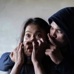 9 Teens Convicted of Gang Rape — Walk Free Without a Single Day in Jail Man holding womans mouth, gesturing silence.