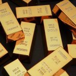 Hidden Hedge: Why Banks Grab Gold Gold bars stacked on dark background