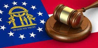 Bureaucrats Beware: Courtroom Bill Lands Georgia flag and judges gavel on wooden base.