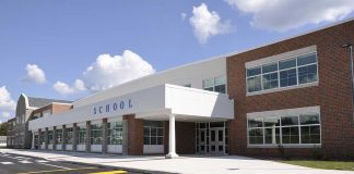 Patriotic Rock Sparks $95K Turnaround Modern school building with large windows and a clear sky