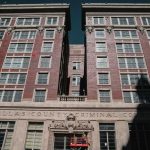 Consent Or Coercion? Pakistan Court Rules Dallas County Criminal Courts building facade with worker on lift
