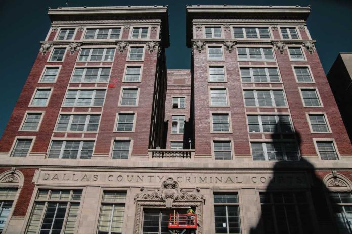 dallas-county-criminal-courts-building1906961278jpg Dallas County Criminal Courts building facade with worker on lift