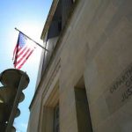 Biden Ends Program — Tactics Quietly Return United States flag Department of Justice building exterior