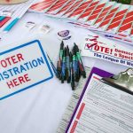 Election Tech Vulnerable—They Knew Voter registration table with forms, pens, and informational materials