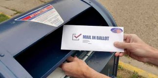 Voter Lists Leak Risk? Barcode Dragnet Looms Person mailing a ballot into a blue street mailbox