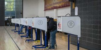 Virginia Twist: Ballots Without Photos? Voters at polling booths in a gymnasium
