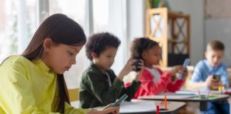 Shocking Failures — Abusers Slipped Through Students using smartphones at classroom desks