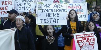 Feds Raided — Now Chicago Wants Payday Protesters march holding signs and banners