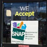 Store window sign indicating SNAP acceptance